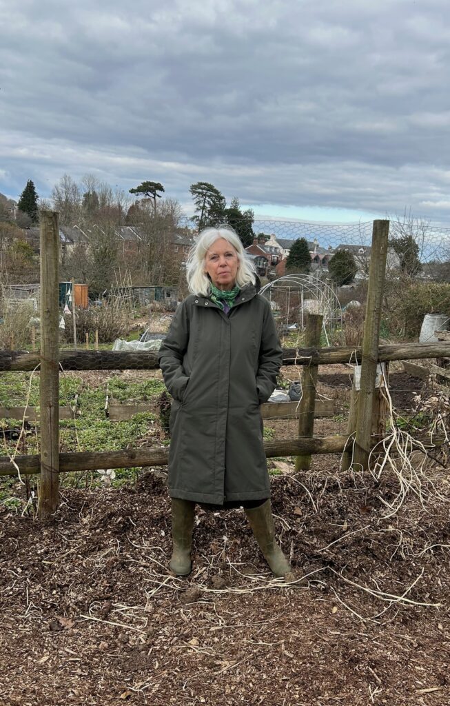 Cllr Jacqi Hodgson stands outside Totnes Allotments